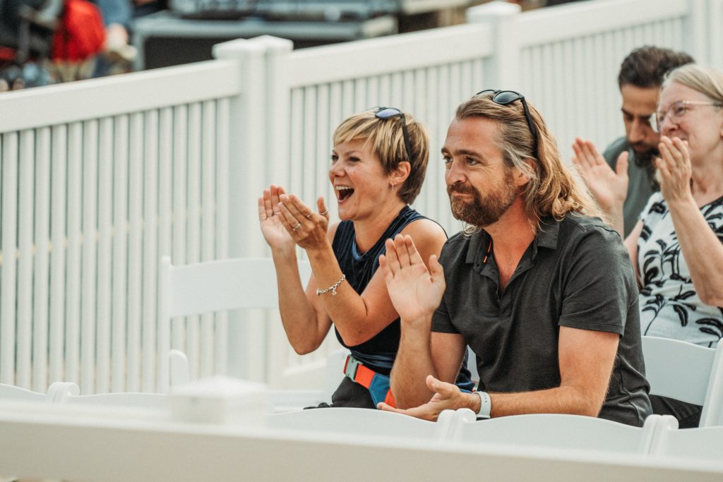 Audience Members clap during the 2024 Omaha Showcase at Gene Leahy Mall in Omaha.