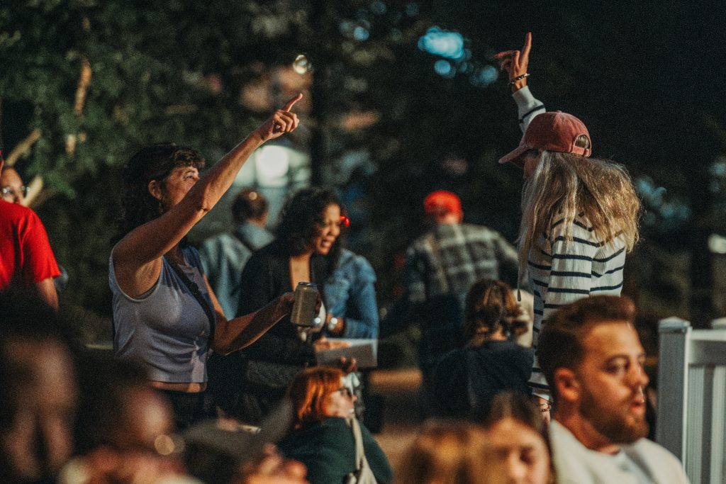 Audience members dancing and enjoying the atmosphere at the 2023 Nebraska Crossroads Music Festival Omaha Showcase at Gene Leahy Mall