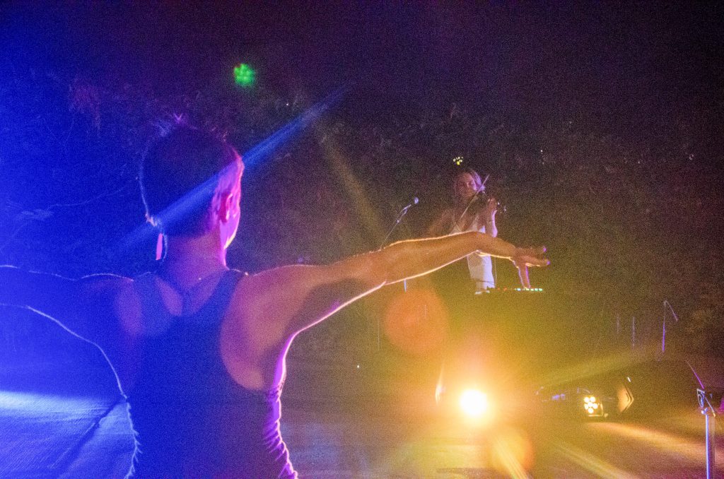 A dancer stretches her arms wide while Olga Smola performs a DJ set with violin at the 2021 Nebraska Crossroads Music Festival in Lincoln